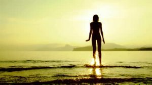 stock-footage-silhouette-of-a-woman-standing-on-the-shore-and-thinking-about-something